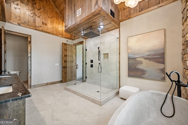 bathroom featuring vanity, plus walk in shower, and a towering ceiling