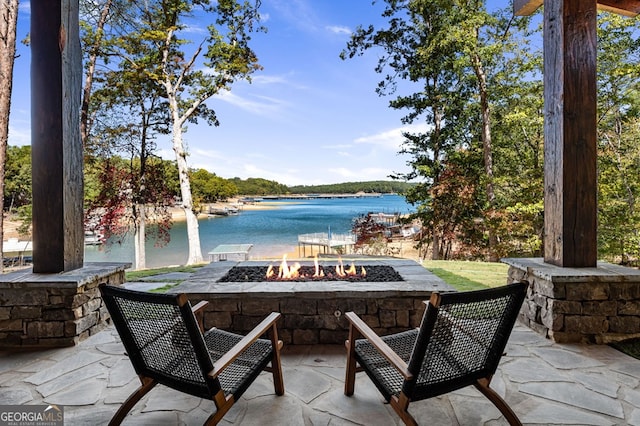 view of patio / terrace with a water view and a fire pit