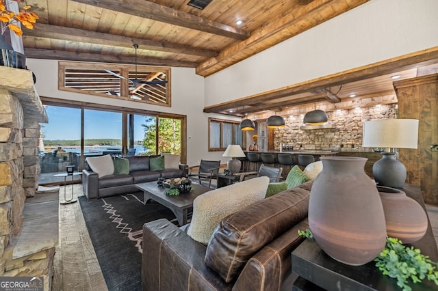 living room featuring beam ceiling, high vaulted ceiling, and wooden ceiling