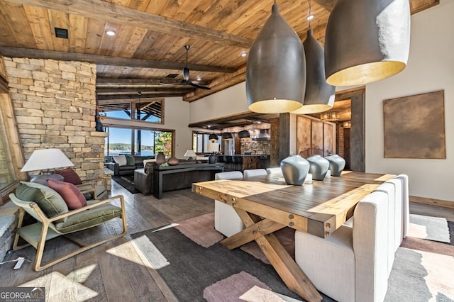 dining space featuring vaulted ceiling with beams, hardwood / wood-style flooring, wooden ceiling, and ceiling fan