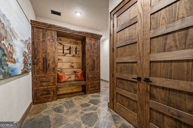 hallway with a textured ceiling