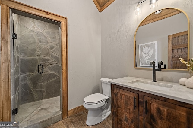 bathroom featuring hardwood / wood-style flooring, toilet, crown molding, vanity, and an enclosed shower