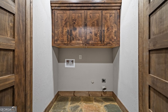 washroom with electric dryer hookup, washer hookup, and cabinets