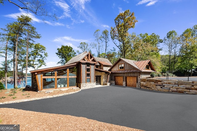 view of front facade featuring a water view and a garage