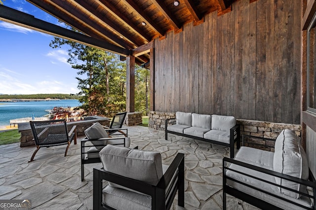 view of patio featuring outdoor lounge area and a water view