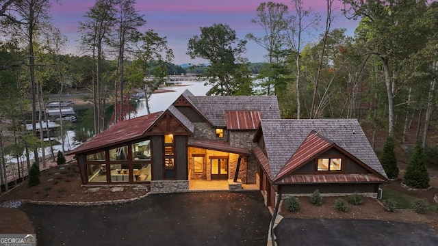 view of front of house with a water view