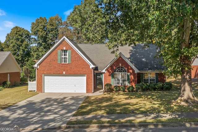 view of front of house with a garage and a front lawn