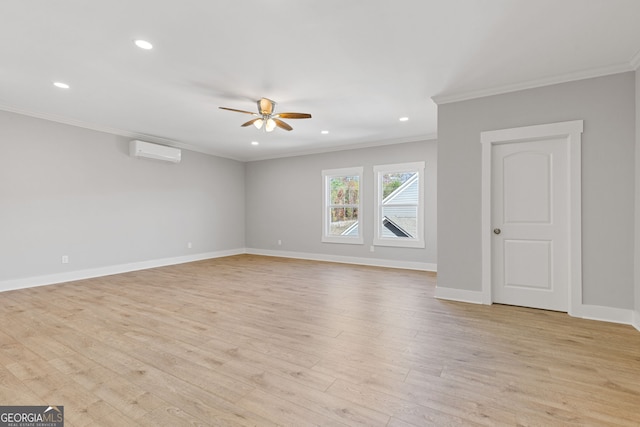 interior space with crown molding, a wall unit AC, light wood-style flooring, and baseboards