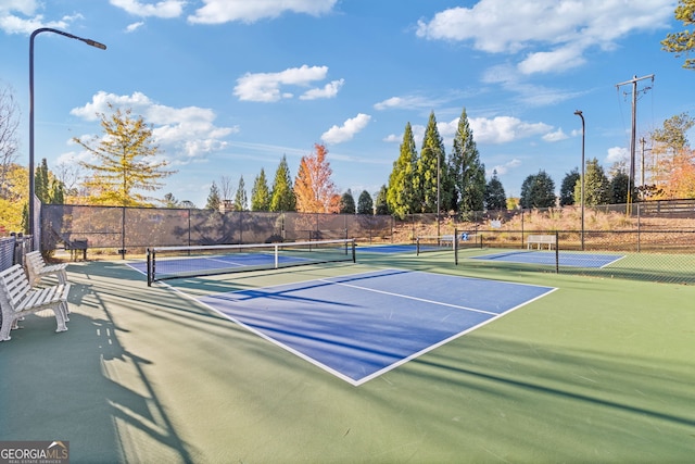 view of tennis court featuring fence