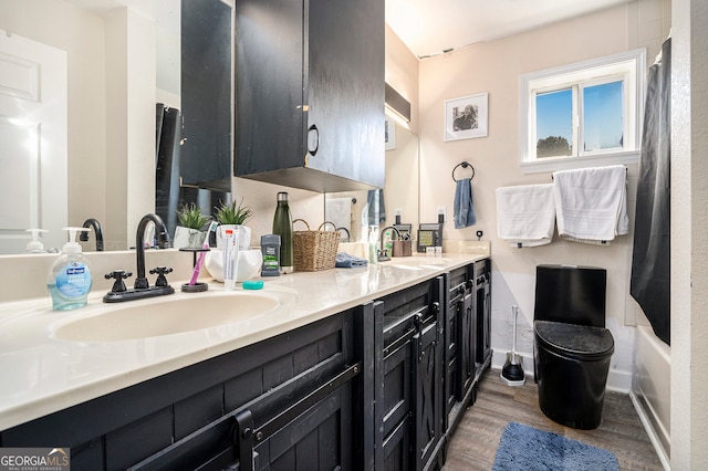 bathroom featuring vanity, wood-type flooring, and tub / shower combination