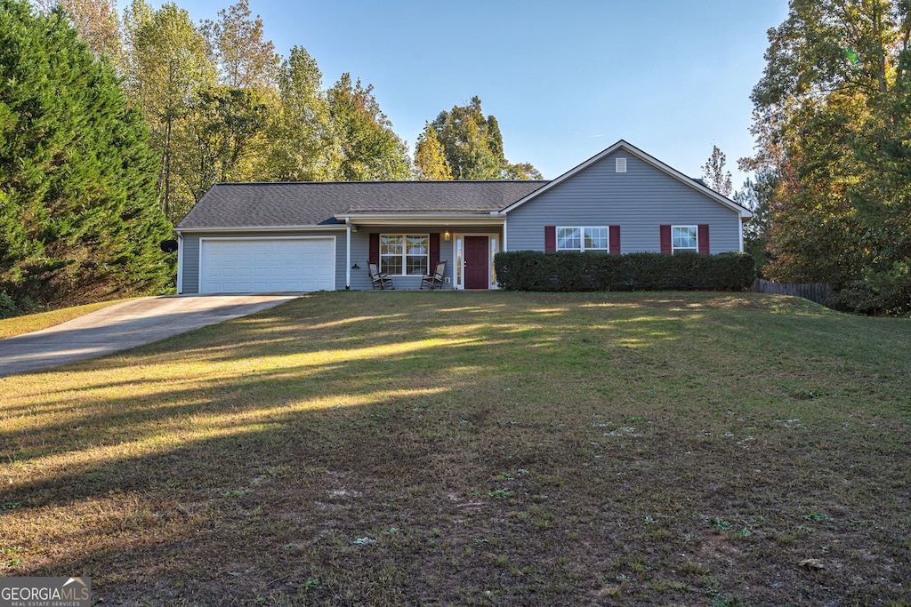 single story home featuring a front yard and a garage