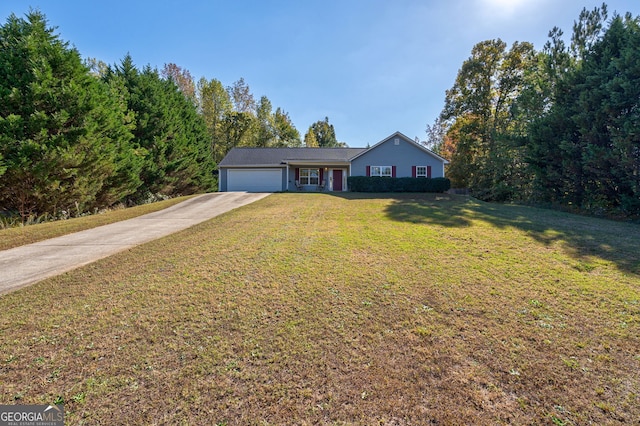 view of front of property with a front yard and a garage