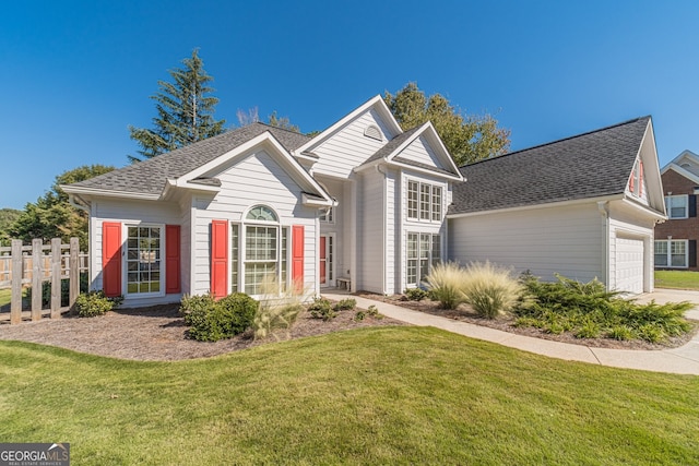 view of front of home with a garage and a front lawn