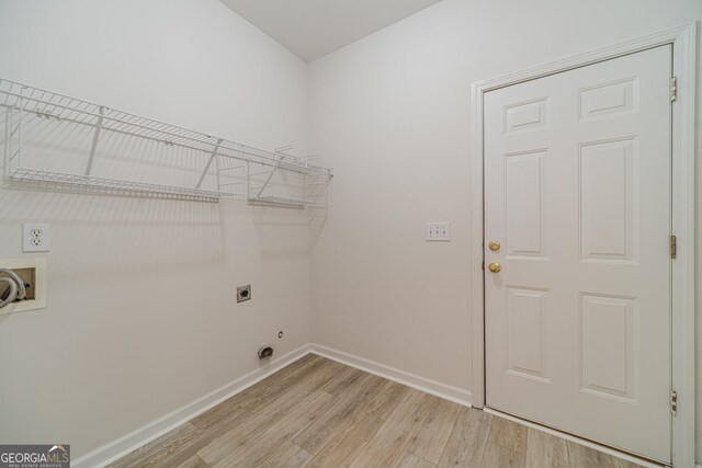 laundry room with light hardwood / wood-style flooring, hookup for a washing machine, and hookup for an electric dryer