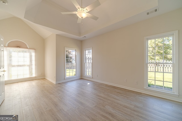 spare room featuring high vaulted ceiling, light hardwood / wood-style floors, a healthy amount of sunlight, and ceiling fan