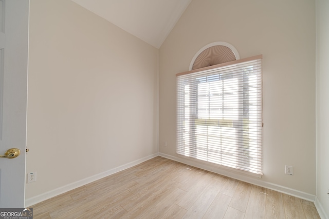 unfurnished room featuring high vaulted ceiling and light wood-type flooring