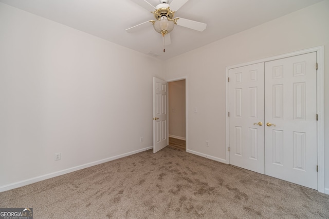 unfurnished bedroom with a closet, carpet, and ceiling fan