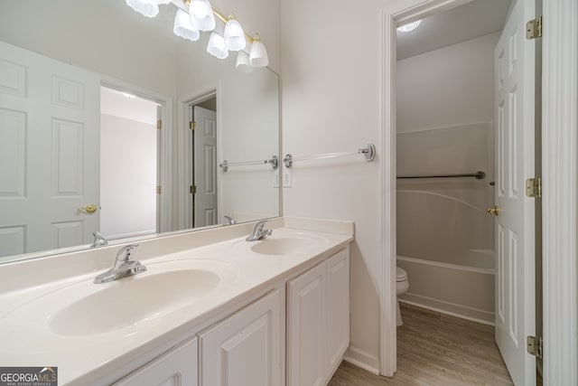 bathroom featuring vanity, hardwood / wood-style flooring, and toilet