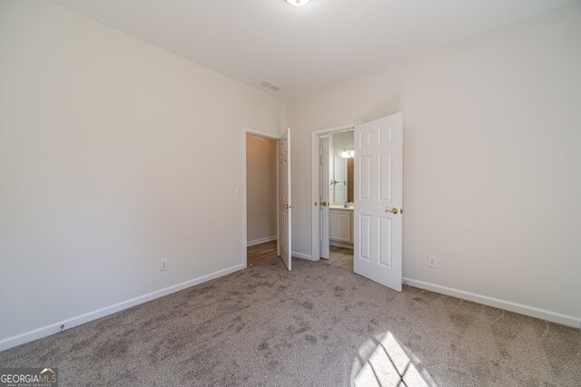 unfurnished bedroom with light carpet