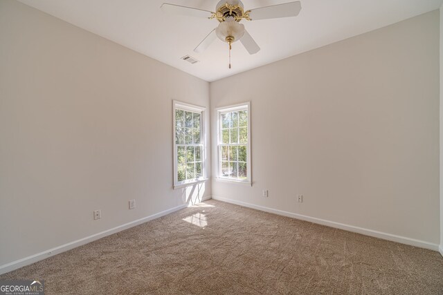 unfurnished room featuring ceiling fan and carpet floors