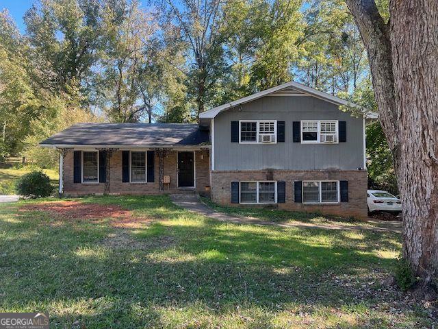 split level home featuring a front lawn