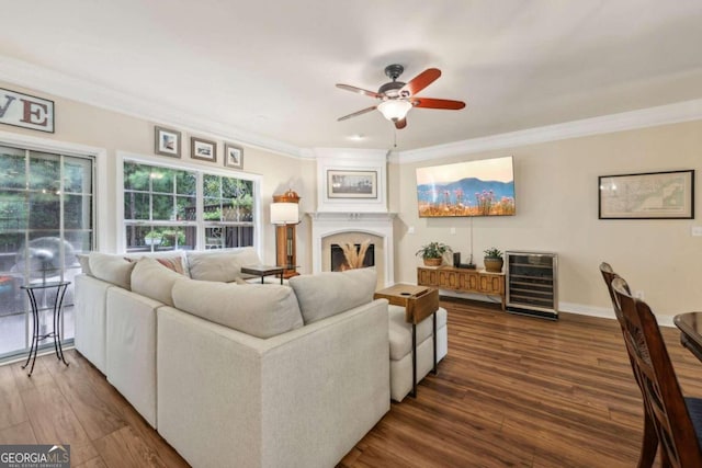 living room with ceiling fan, crown molding, wine cooler, and dark hardwood / wood-style flooring