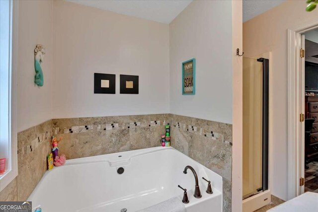 bathroom featuring separate shower and tub