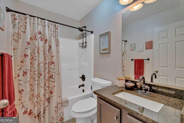 full bathroom with vanity, shower / bath combo with shower curtain, and toilet