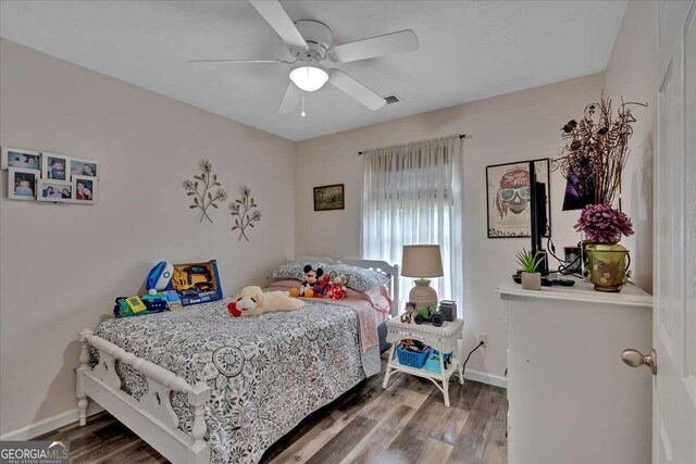 bedroom with hardwood / wood-style floors and ceiling fan