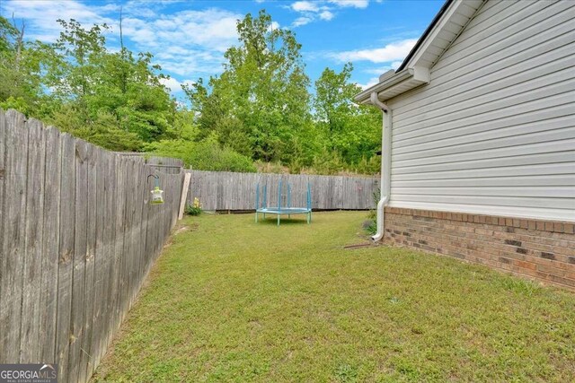 view of yard with a trampoline