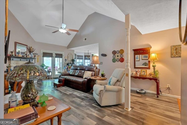 living room featuring french doors, hardwood / wood-style flooring, high vaulted ceiling, and ceiling fan