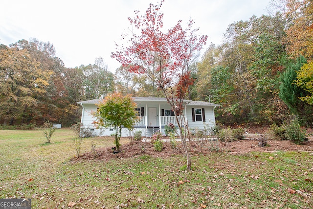 view of front of home with a porch and a front lawn