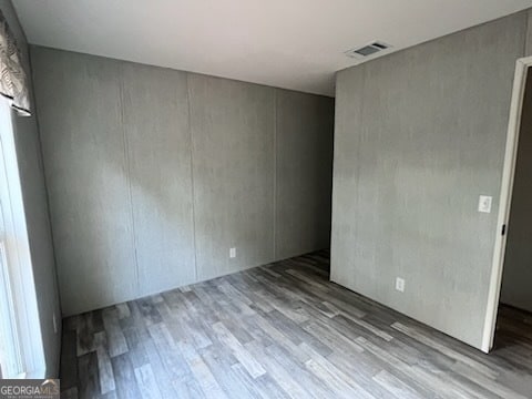 empty room featuring wood-type flooring