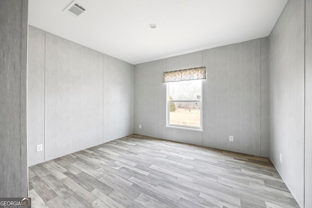 unfurnished room featuring light hardwood / wood-style floors