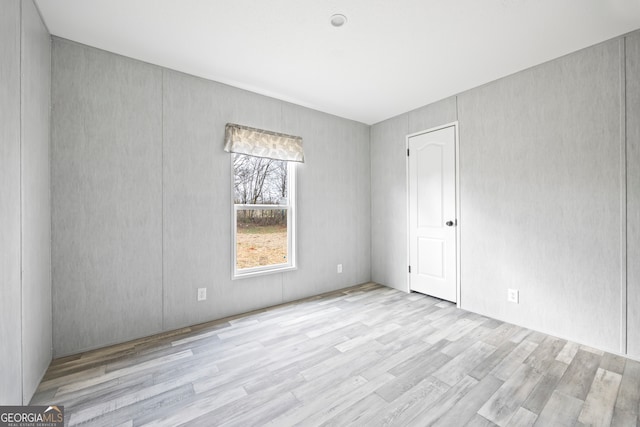 spare room with light hardwood / wood-style floors