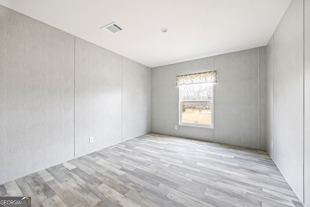 empty room with light hardwood / wood-style floors