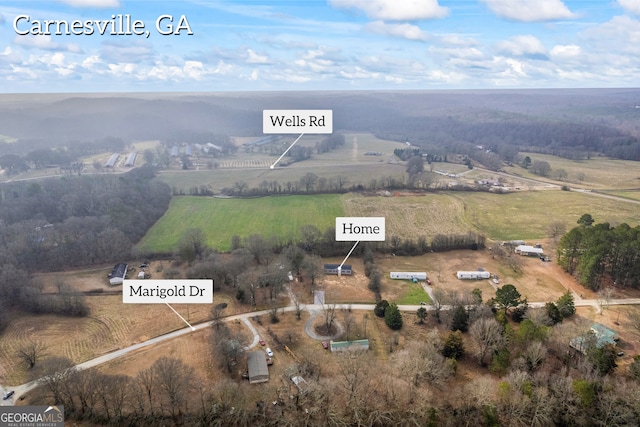 birds eye view of property featuring a rural view