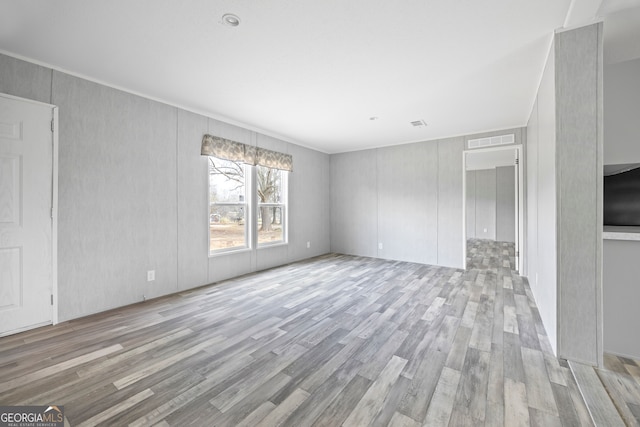 unfurnished living room featuring light hardwood / wood-style flooring