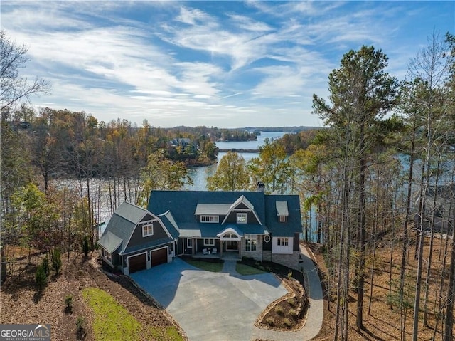 view of front of home with a garage and a water view