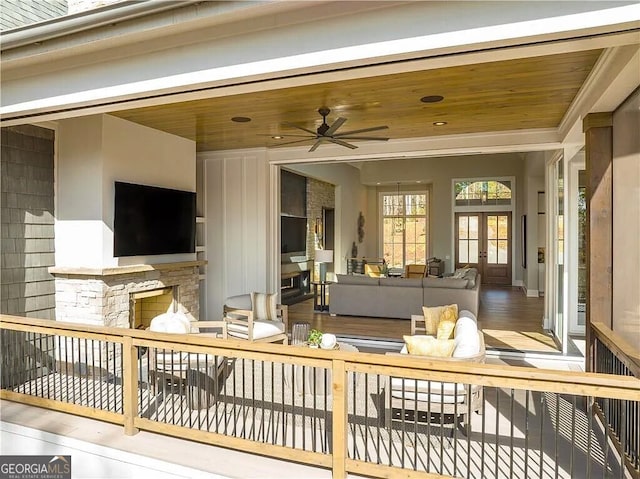 sunroom / solarium featuring wood ceiling, french doors, and ceiling fan