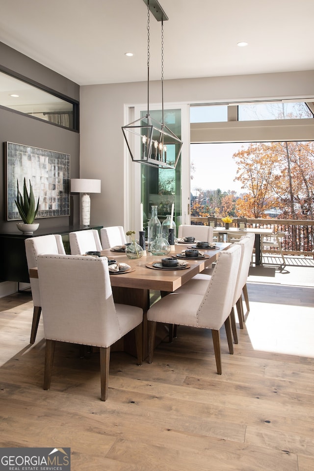 dining area with a chandelier and light hardwood / wood-style flooring