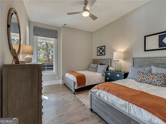 bedroom with light hardwood / wood-style flooring and ceiling fan