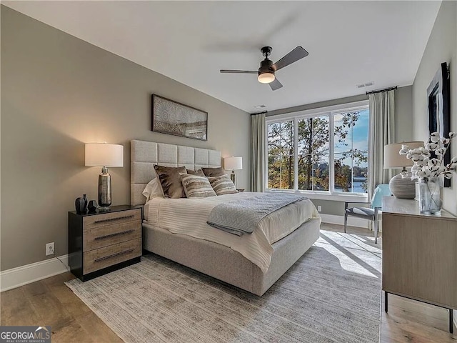 bedroom with wood-type flooring and ceiling fan