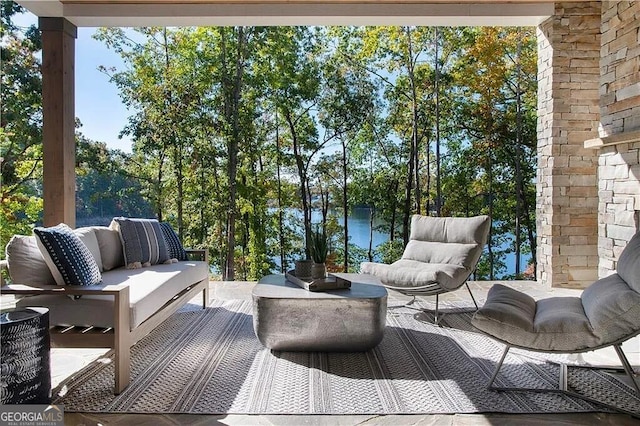 wooden terrace with an outdoor living space