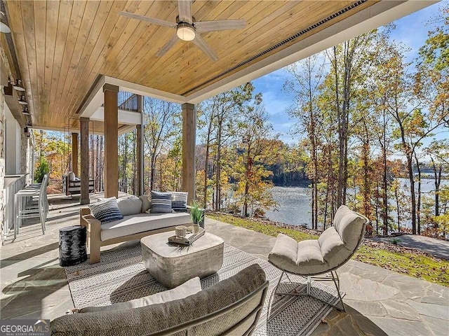 view of patio featuring an outdoor living space, a water view, and ceiling fan