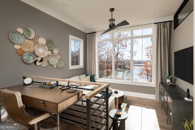 dining area with hardwood / wood-style floors, crown molding, and ceiling fan