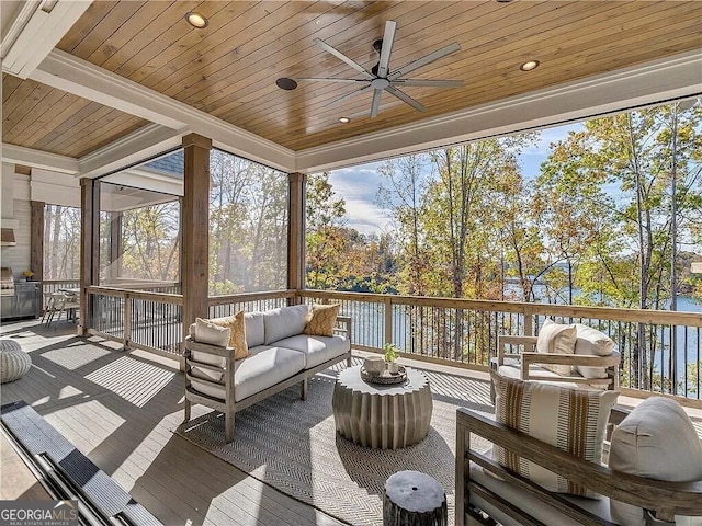 sunroom / solarium with a water view, ceiling fan, and wooden ceiling