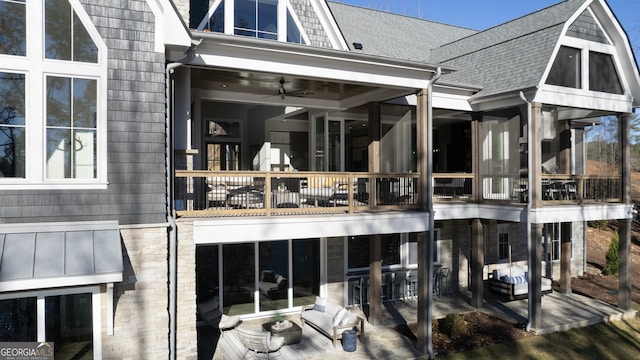 exterior space featuring ceiling fan and a balcony