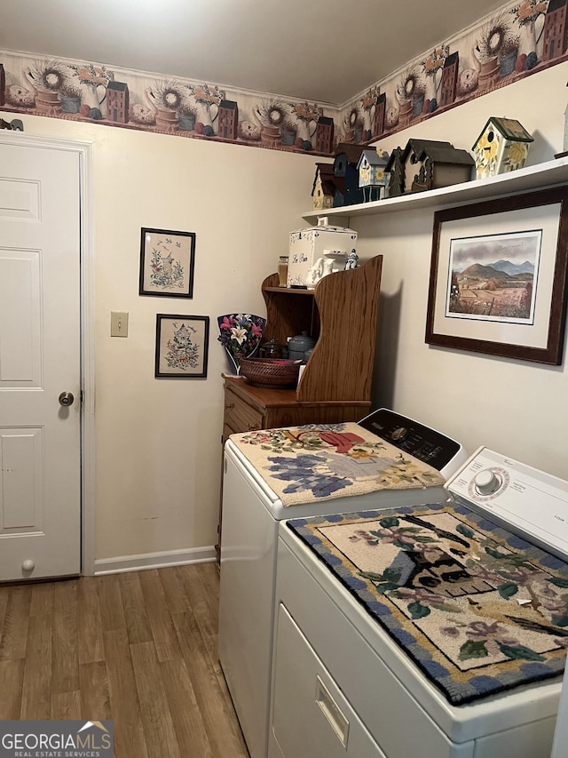 clothes washing area featuring wood finished floors, separate washer and dryer, laundry area, ornamental molding, and baseboards