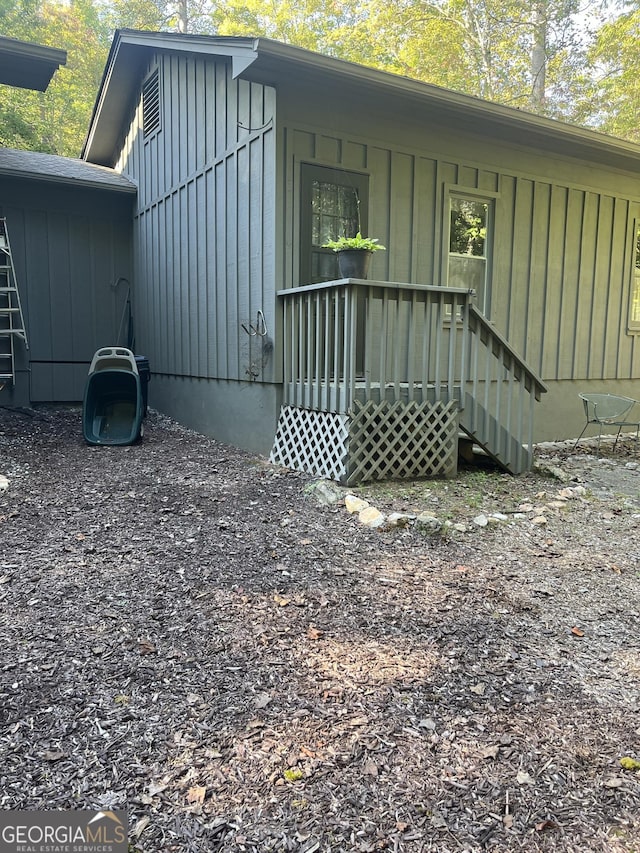 view of exterior entry featuring board and batten siding